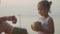 Travelers mother and daughter sits at seafront and drinks coconats in trip