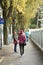 Travelers people walking at footpath beside road in small alley