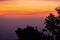 Travelers silhouettes standing on rocks with light sunrise