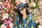 Travelers thai woman travel and posing for take photo with colorful flowers background in Hong Kong, China