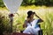 Travelers thai women people sit on seat posing portrait in pavilion thatch in grass field for thai people and foreign travelers