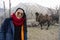 Travelers thai women standing for take photo Bactrian camel inside cage at Hunder of Hunder village in nubra tehsil valley