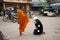 Travelers thai women travel visit and respect praying put food and things offerings to monks on the road front of local market