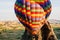 Travelers and tourists flying over mountains at sunset in a colorful aerostat balloon in Goreme, the Turkish cappadocia