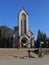 Travelers walking on the sidewalk of the square in front of the Catholic Holy Rosary church in Sapa