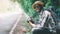 Traveling african male tourist backpackers taking photo side of the highway road.Adventure travel concept