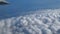 Traveling by air. Bird`s eye view through an airplane window. Beautiful cloudscape