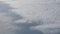 Traveling by air. Bird`s eye view through an airplane window. Beautiful cloudscape