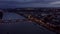 Traveling back drone shot of the City of Mainz in Germany at night showing the bridge and the Rhine river