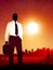 Traveling Businessman on sunset background