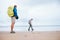 Traveling with child: father and son enjoyed empty ocean beach