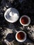 Traveling concept. Making black tea in white Chinese gaiwan and cups on big rock top view