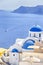 Traveling Concepts. Sailing Boat Near Caldera Volcanic Slopes of Santorini Oia or Ia Village in Greece. With Traditional Blue and