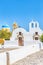 Traveling Concepts. View of Traditional Greek Churches and Houses of Oia or Ia at Santorini Island in Greece With Cross and Bells