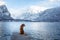 Traveling with a dog in Autria. Nova Scotia Duck Tolling Retriever on the dock in a mountain lake.