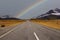 The traveling explore on the road as rainbow with mountain range near Aoraki Mount Cook and the road leading to Mount Cook in