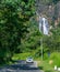 Traveling highlands of Sri Lanka, Distant Rawana falls in the background and lush green surroundings, beautiful paradise in south