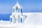 Traveling Ideas and Concepts. View of Traditional Blue and White Greek Church With Bell and Cross in Oia or Ia Village at