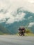 Traveling motorcycle with foggy green mountain background