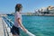 Traveling teenager girl on sea bay Mirabello enjoys beauty nature