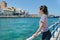 Traveling teenager girl on sea bay Mirabello enjoys beauty nature