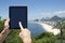 Traveling Tourist Using Tablet at Rio de Janeiro Brazil Beach