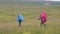 Traveling woman with backpack walking on green hills on mountain landscape