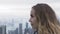 Traveling woman watching Hong Kong city panorama from Peak Victoria. Portrait tourist european woman enjoying panoramic