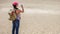 Traveller drinking water from bottle in the desert