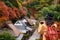 Traveller girl take a photo for the traditional japanese hut a autumn background