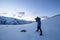 A traveller hiking to the top of snow mountain and take pictures in south island, New Zealand