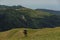 Traveller looks at the scenery with hills and forest