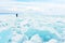 Traveller looks to a field of ice covering Baikal lake in winter.