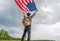 Traveller man holding american usa flag outdoor with storm cloud