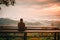 Traveller man looking Foggy in the mountains with dramatic sky at sunrise