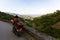 Traveller on a motorbike rides on a serpentine road to the viewpoint of the Douro Valley, Porto