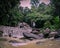 Traveller Stading On A Rock At Kathu Waterfall