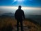 A traveller standing at cliff of a hill in Kasauli Himachal Pradesh India under clear sky sunlight landscape