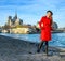 Traveller woman standing on embankment near Notre Dame de Paris