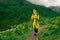 Traveller woman walking in mountain valley in rainy day