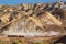 Travellers with camels in Colorful mountain in Danxia landform in Zhangye, Gansu of China