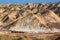 Travellers with camels in Colorful mountain in Danxia landform in Zhangye, Gansu of China