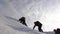 Travellers climb rope to their victory through snow uphill in a strong wind. Tourists in winter work together as team
