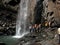 Travellers enjoying near waterfall