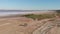 Travellers ride bikes around Kuyalnik estuary, aerial drone view. Bike riders is travelling along dried salt shore on Kuyalnik Lim