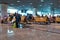 Travellers wait at a airport departure gate before boarding their flight