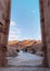 Travelling in Petra, the rose city in Jordan. Couple walking through ancient arch in Amman, Jordan, Middle East