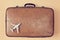 Travelling by plane. Travel background. Grandparents trip. Vintage shabby suitcase and model of airplane, copy space