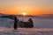 Travelling in winter at lake Baikal in Irkutsk, Russia. Winter landscape in sunset with young woman using mobile smart phone and e