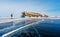 Travelling in winter, a man walking on frozen lake Baikal in Siberia, Russia